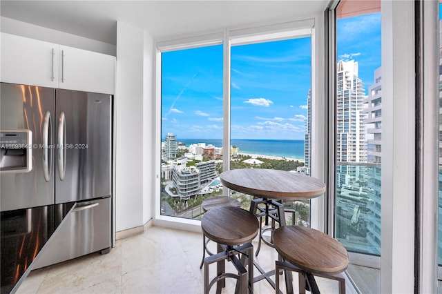 dining space featuring a water view and a wealth of natural light