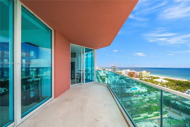 balcony with a beach view and a water view