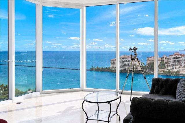 sunroom / solarium with a water view