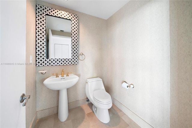 bathroom featuring tile patterned flooring and toilet