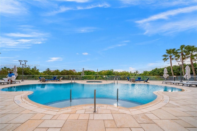 view of pool featuring a patio area and a hot tub