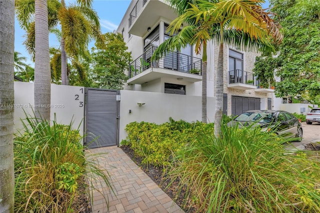 909 NE 16th Ter Unit 2, Fort Lauderdale, FL 33304 - view of home's exterior with stucco siding, a gate, and a balcony
