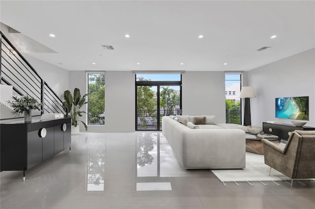 living room with a wealth of natural light and a wall of windows