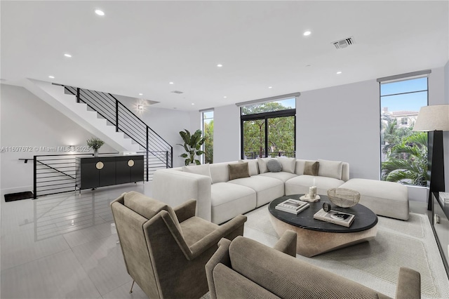909 NE 16th Ter Unit 2, Fort Lauderdale, FL 33304 - living room featuring healthy amount of natural light, stairs, and recessed lighting