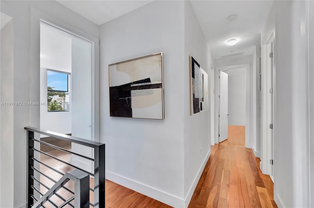 909 NE 16th Ter Unit 2, Fort Lauderdale, FL 33304 - hall featuring light wood-type flooring and an upstairs landing