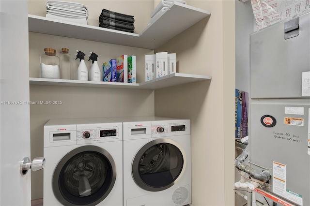 909 NE 16th Ter Unit 2, Fort Lauderdale, FL 33304 - laundry area featuring washing machine and clothes dryer and heating unit