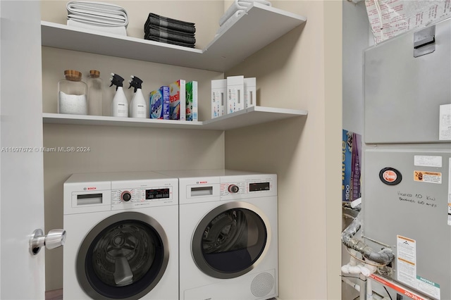 washroom with washer and dryer and heating unit