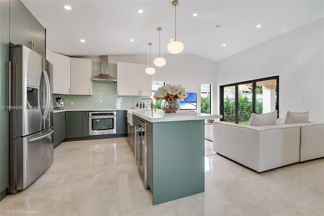 14584 SW 115th St, Miami, FL 33186 - kitchen featuring stainless steel appliances, wall chimney range hood, light countertops, vaulted ceiling, and tasteful backsplash