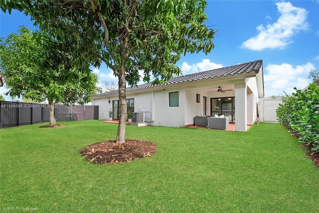 14584 SW 115th St, Miami, FL 33186 - back of house featuring ceiling fan, an outdoor living space, a fenced backyard, stucco siding, and a patio area