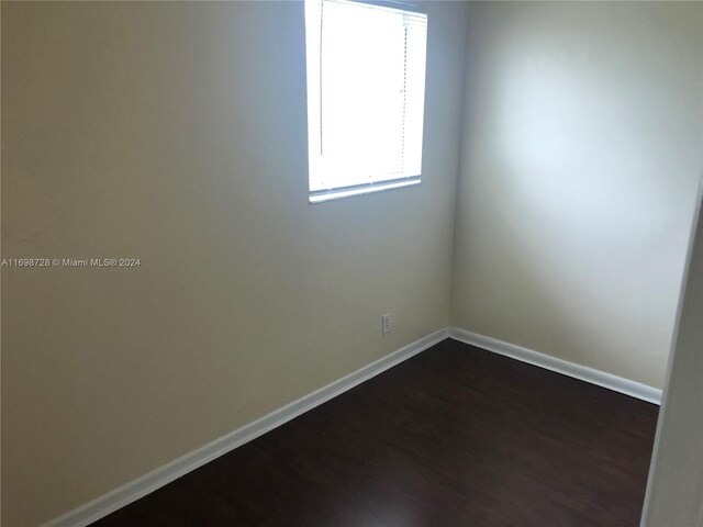 empty room with dark hardwood / wood-style floors