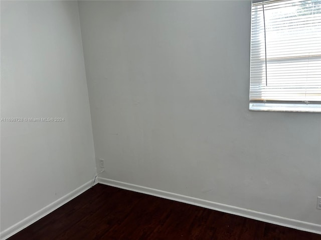 unfurnished room with wood-type flooring