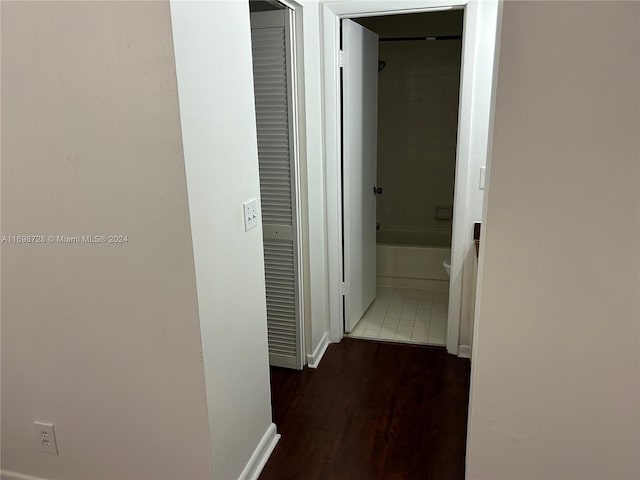 hallway with dark tile patterned flooring