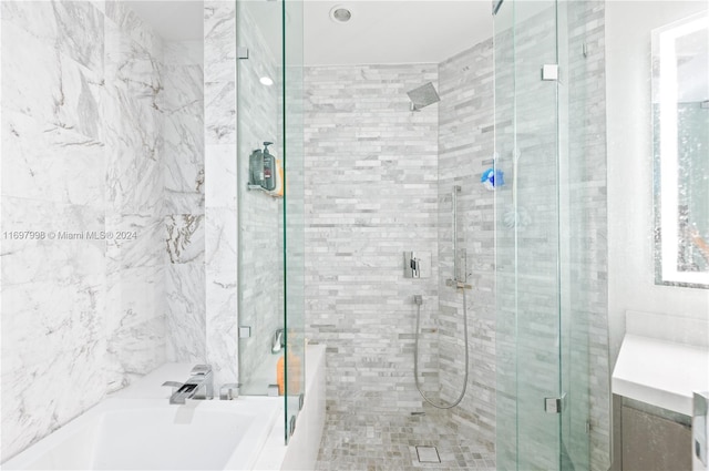 bathroom with separate shower and tub