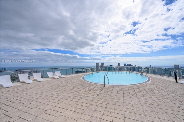 view of pool featuring a water view