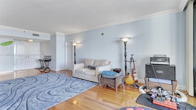 living room with wood-type flooring and ornamental molding