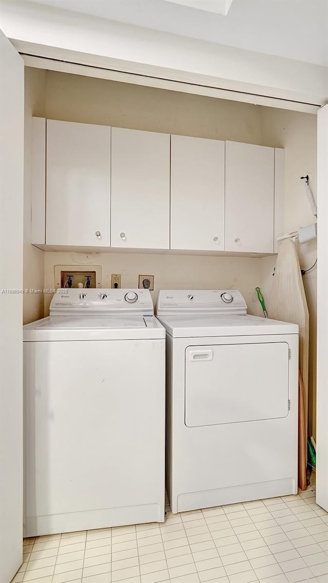 laundry area featuring washing machine and dryer and cabinets