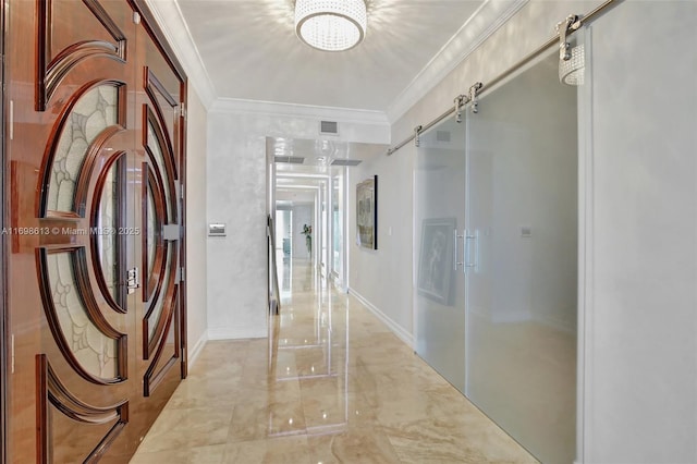 hall with a barn door and crown molding