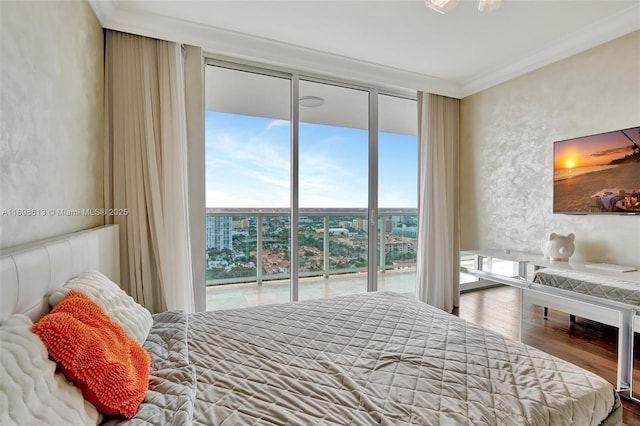 bedroom with access to exterior, hardwood / wood-style flooring, a wall of windows, and ornamental molding