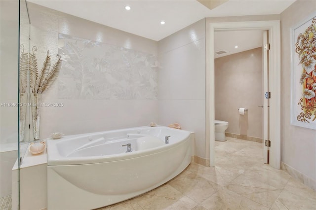 bathroom featuring a tub to relax in and toilet