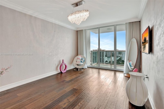 miscellaneous room featuring dark hardwood / wood-style floors, a wall of windows, crown molding, and a notable chandelier