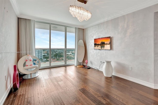 unfurnished room with ornamental molding, hardwood / wood-style flooring, floor to ceiling windows, and a notable chandelier