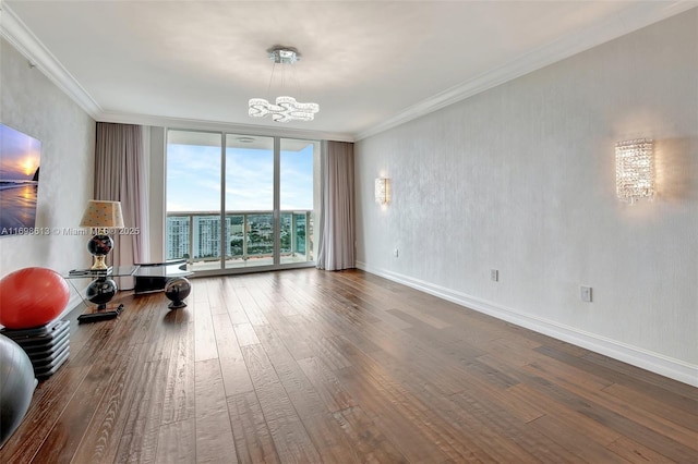 exercise room featuring crown molding, hardwood / wood-style floors, a chandelier, and a wall of windows