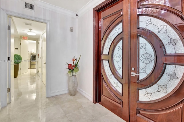 foyer featuring crown molding and french doors