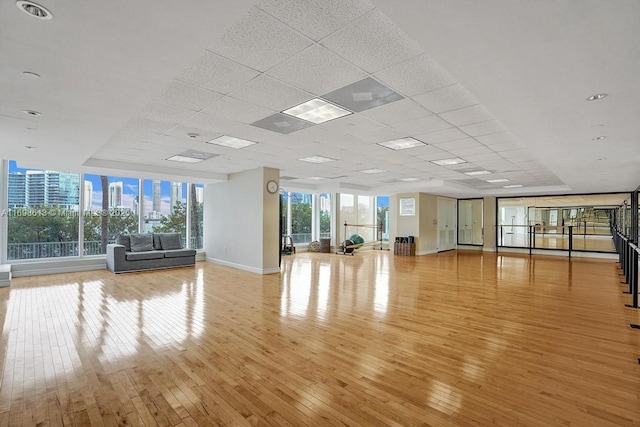 3201 NE 183rd St Unit 2607, Aventura, FL 33160 - exercise area with light wood-style flooring, baseboards, a paneled ceiling, and a city view