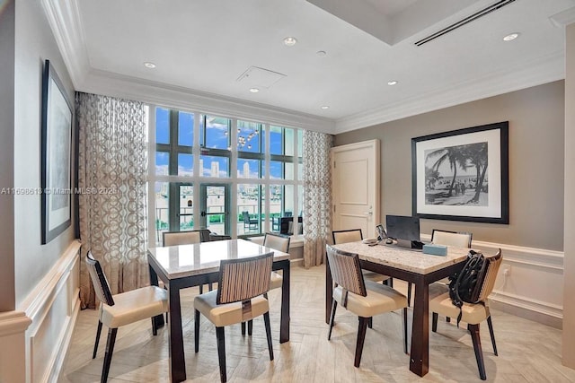 dining area with light parquet flooring and ornamental molding