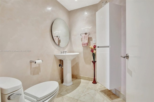 3201 NE 183rd St Unit 2607, Aventura, FL 33160 - bathroom featuring toilet, a sink, and baseboards