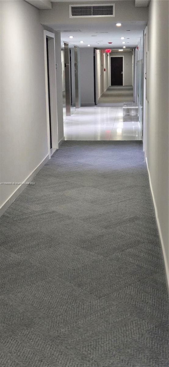 hall with dark carpet