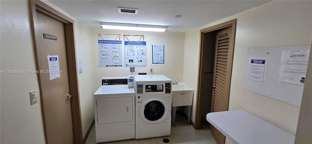 clothes washing area with washer and dryer