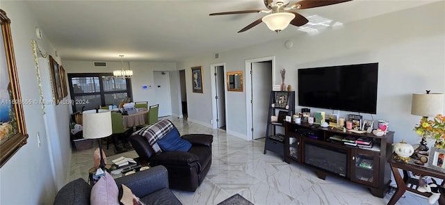 living room with ceiling fan with notable chandelier