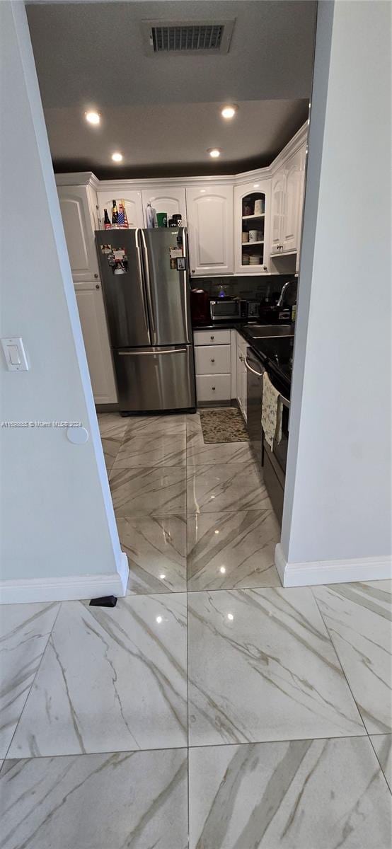 kitchen with white cabinetry, sink, and appliances with stainless steel finishes