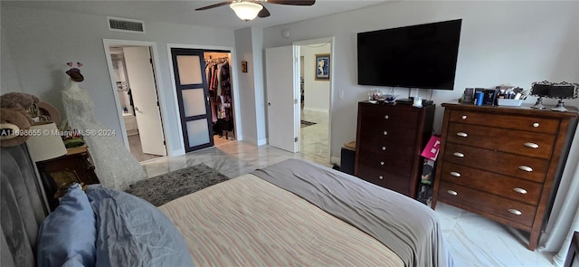 bedroom with ceiling fan, a walk in closet, connected bathroom, and a closet