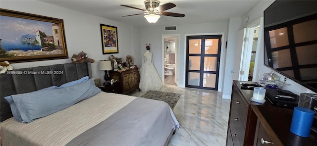 bedroom with ensuite bathroom, sink, and ceiling fan