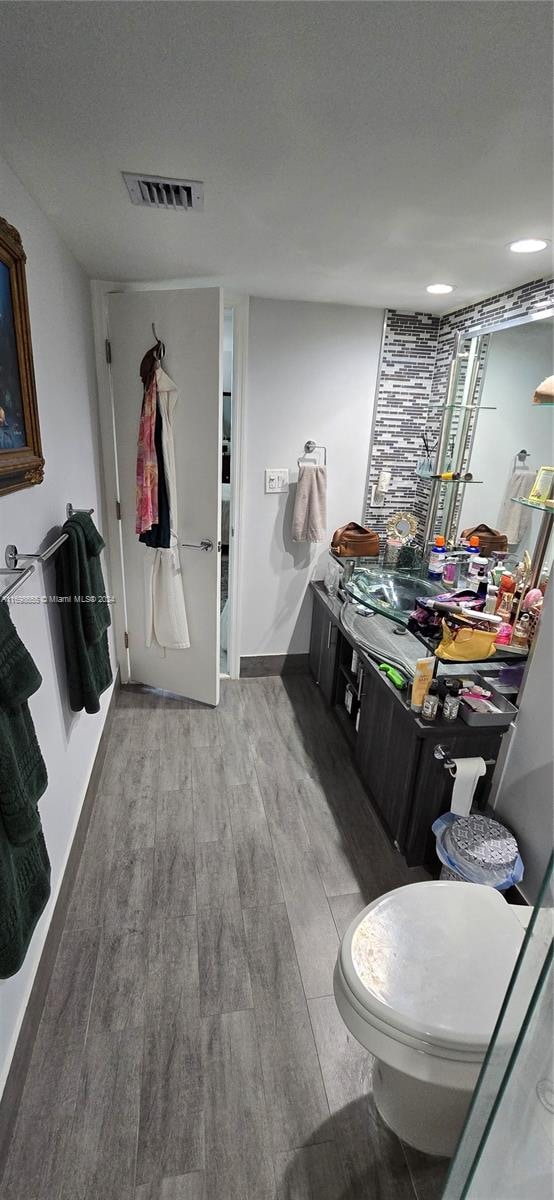 bathroom featuring hardwood / wood-style floors and toilet