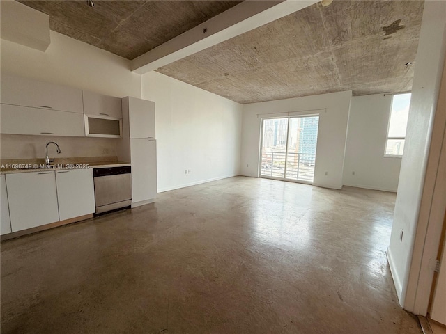 unfurnished living room featuring concrete flooring and sink