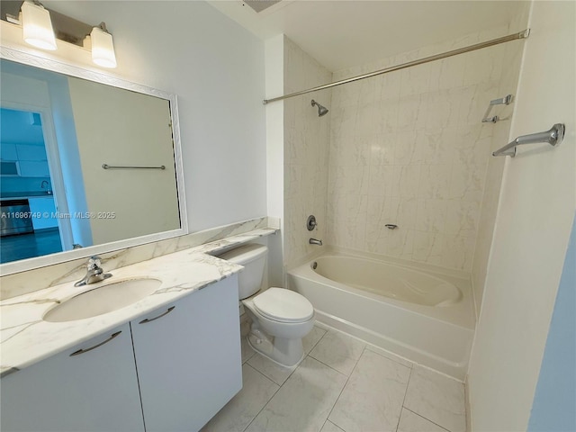 full bathroom featuring vanity, tiled shower / bath, and toilet