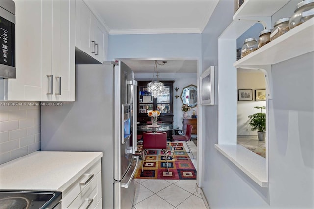 kitchen with white cabinets, decorative light fixtures, decorative backsplash, and appliances with stainless steel finishes