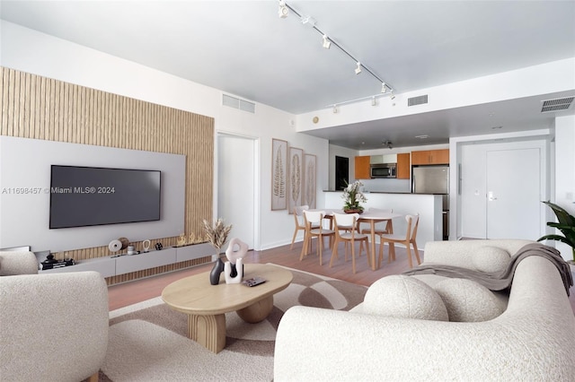 living room with track lighting and hardwood / wood-style flooring