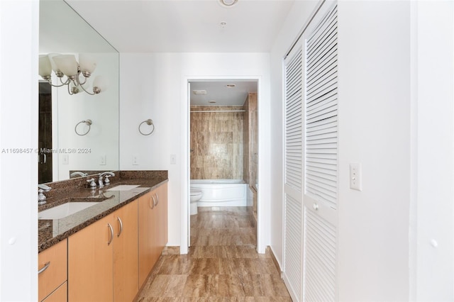 full bathroom featuring vanity, toilet, and tiled shower / bath combo