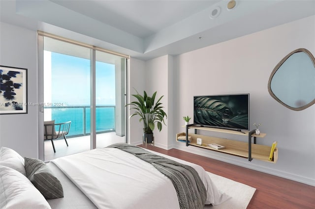 bedroom featuring access to exterior and wood-type flooring