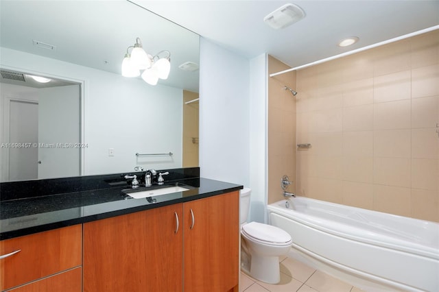 full bathroom with tile patterned floors, tiled shower / bath combo, toilet, and vanity