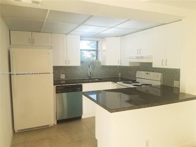 kitchen with white cabinets, a drop ceiling, white appliances, and kitchen peninsula