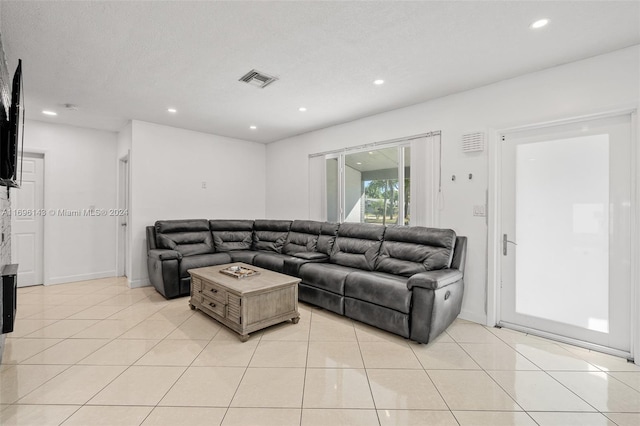 living room with light tile patterned floors and a textured ceiling