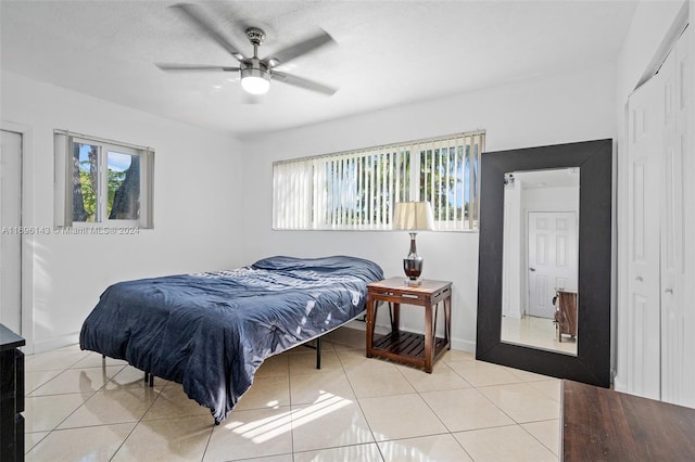 bedroom with ceiling fan and light tile patterned floors