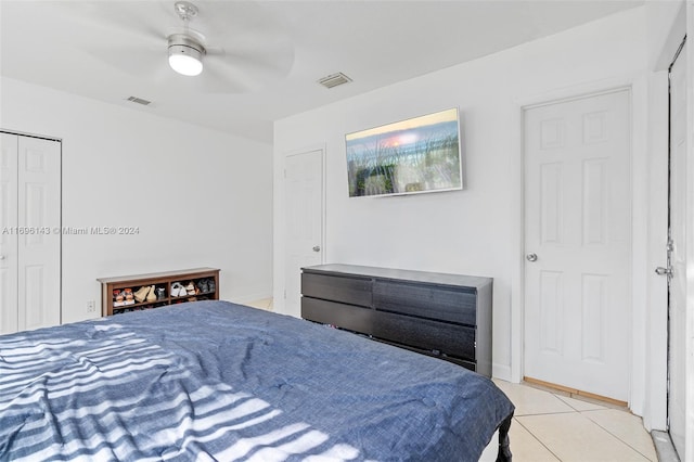 tiled bedroom with a closet and ceiling fan