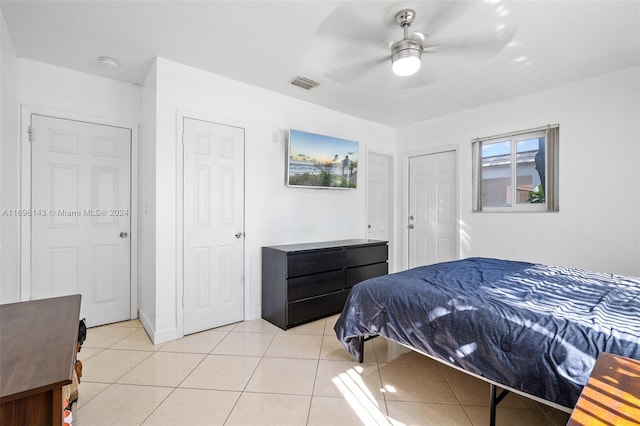 tiled bedroom featuring ceiling fan