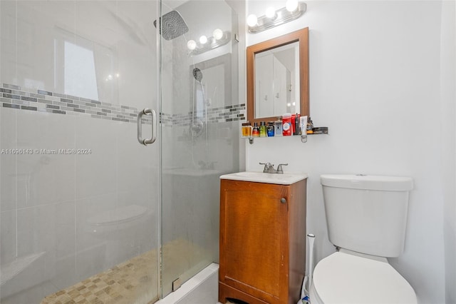 bathroom with vanity, toilet, and an enclosed shower